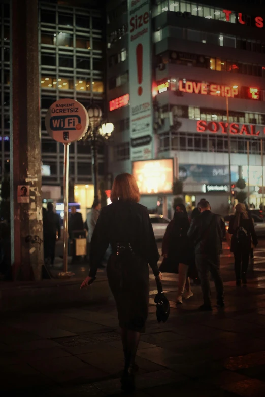 a group of people walking down a sidewalk