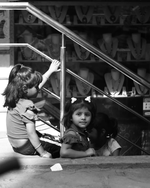 the two girls are sitting on the stairs