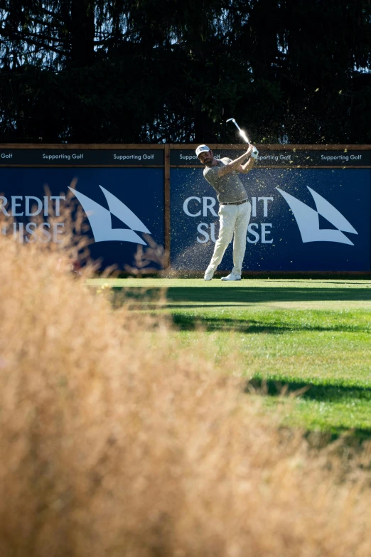 a man in a uniform swinging at a ball