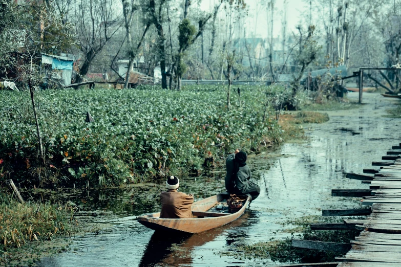 two people on a boat that is floating in the water