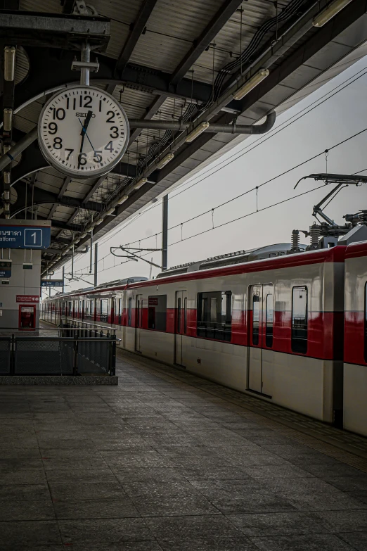 an empty train platform is filled with people waiting to board