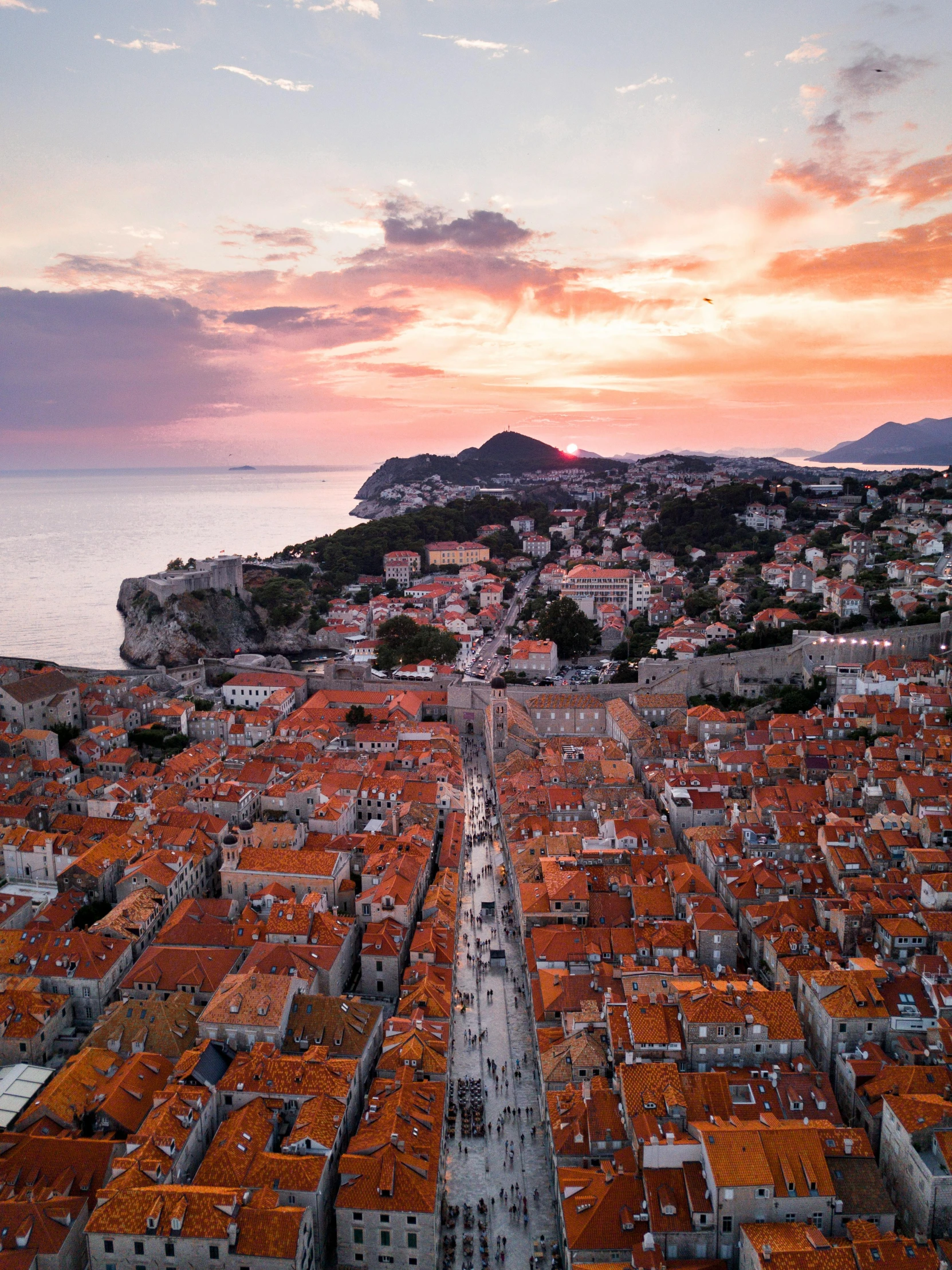 an aerial view of a small city at sunset