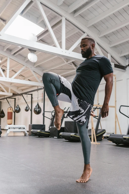 a man doing a kick in a gym