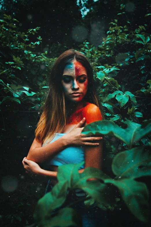 a woman with makeup and face paint is holding an orange