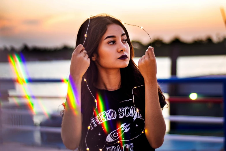 a young woman is holding her ear in the sun