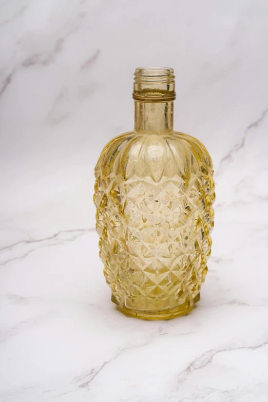 a yellow glass bottle sitting on top of a counter