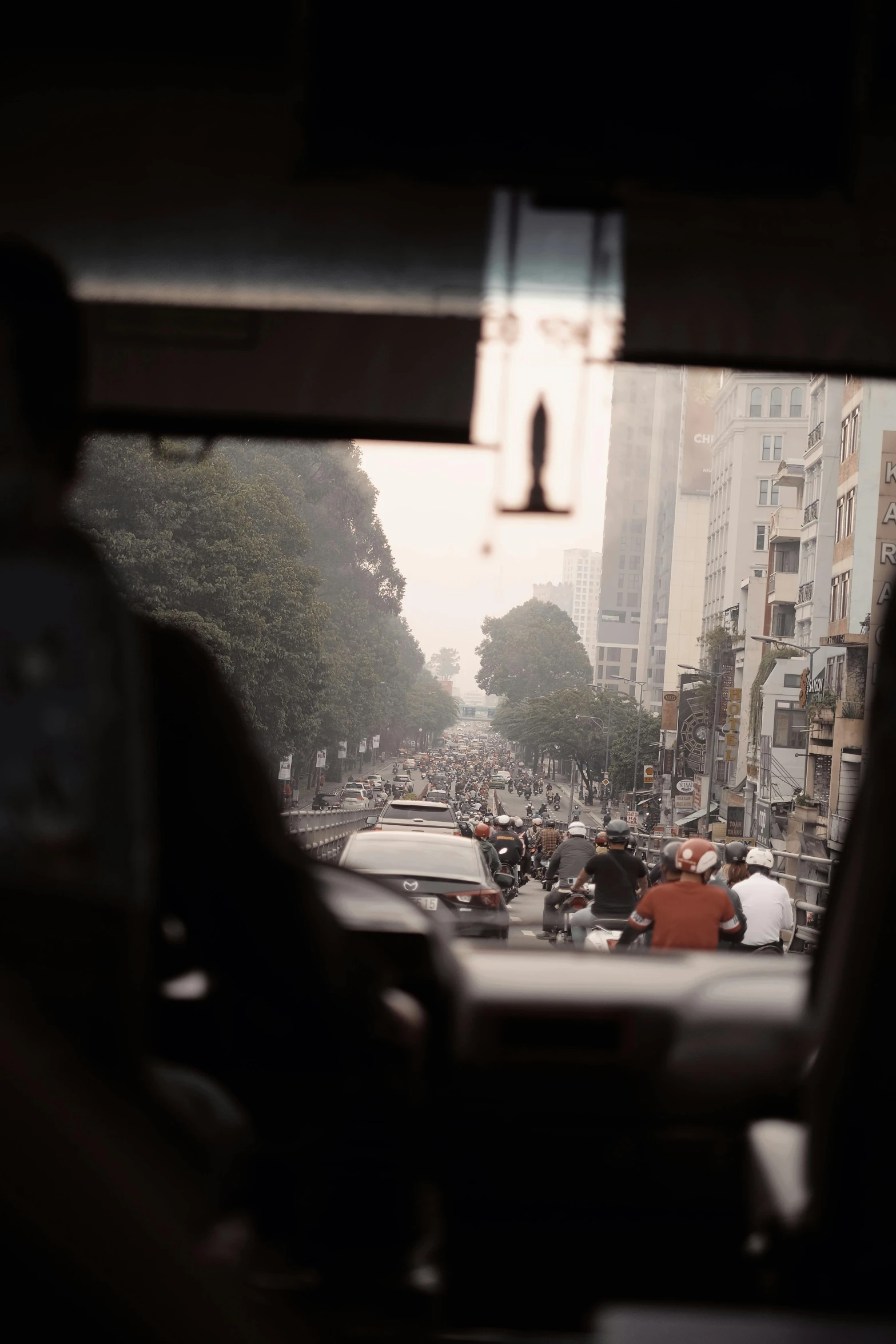 city buildings and people on crowded street from car