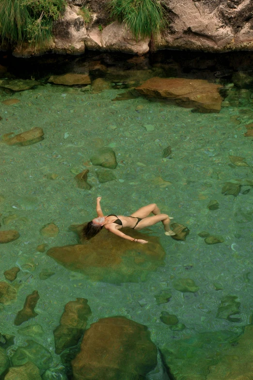 a woman swimming in the crystal waters