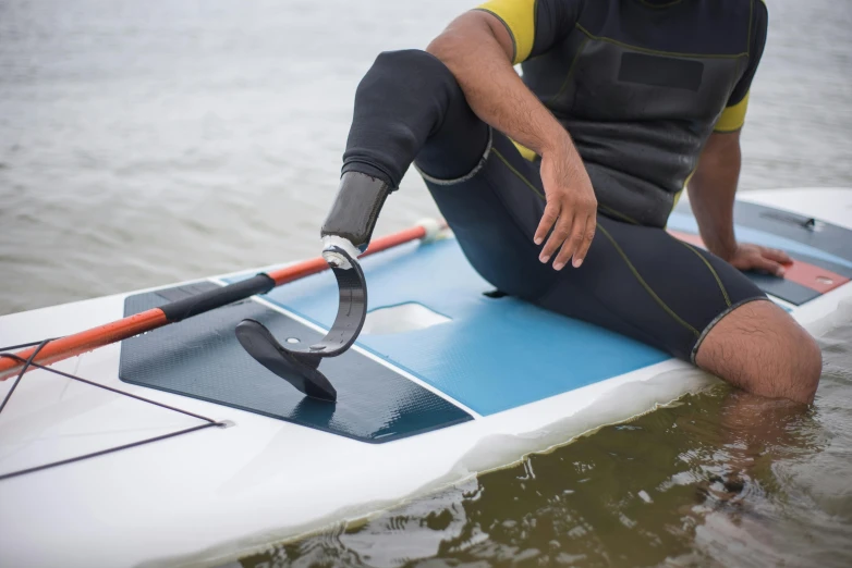 man sitting on a paddle boat in water