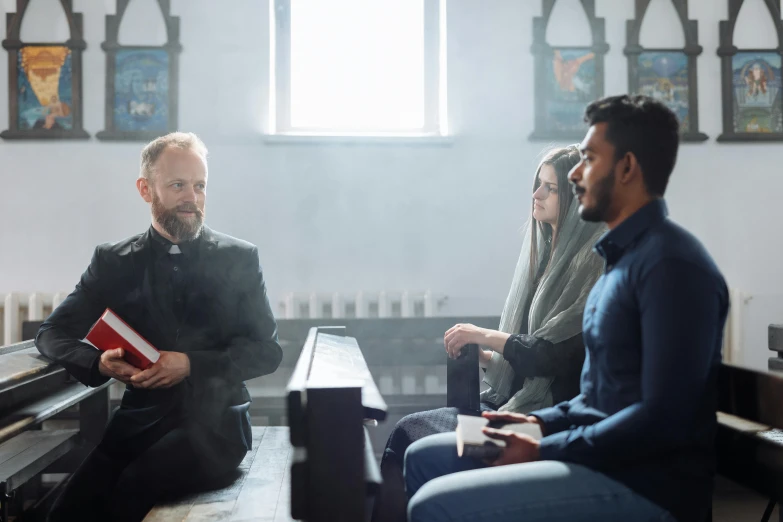 a group of people sitting in the pew of a church