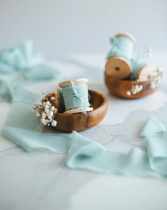 baby's shoes are placed inside a miniature basket