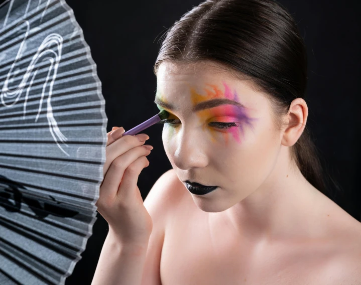 a woman with makeup and umbrella painted on her face