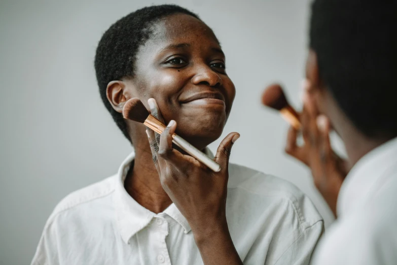 a woman is smiling and holding a crayon