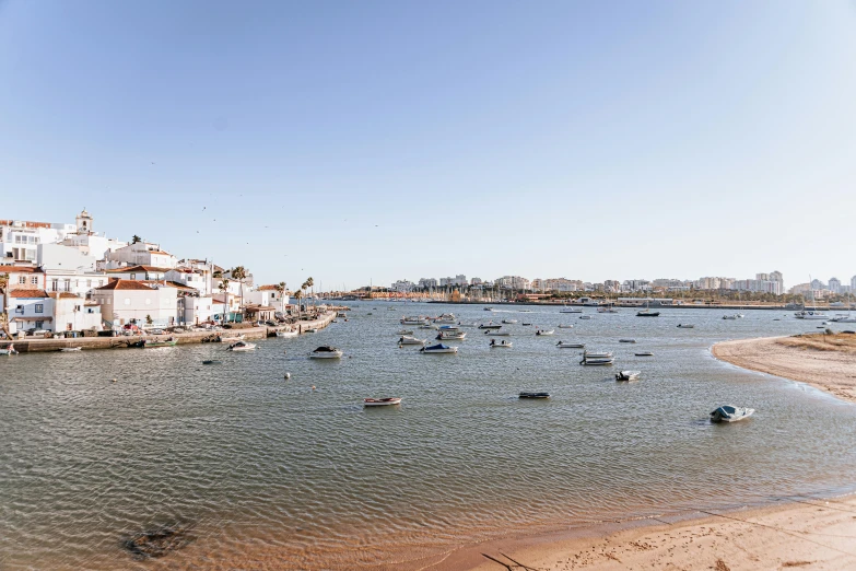 boats on the shore near several buildings