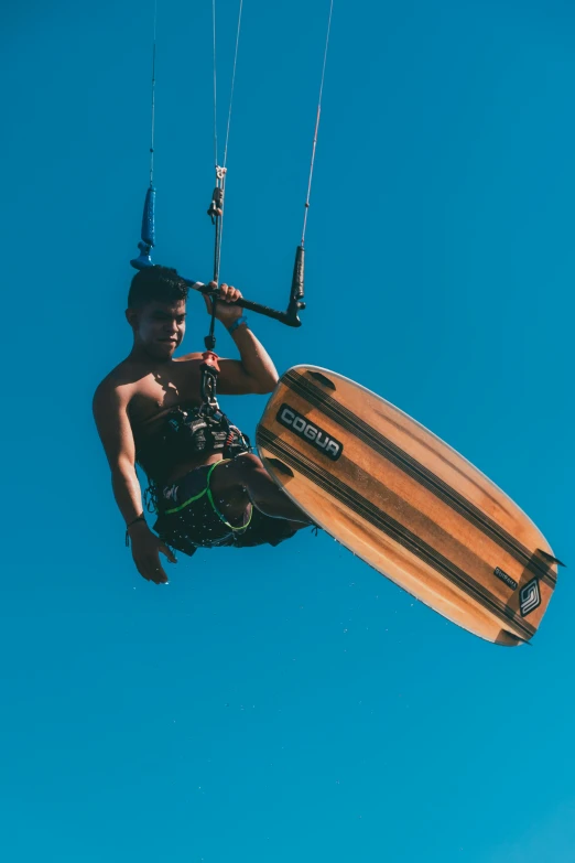 a young man is in the air with his wakeboard