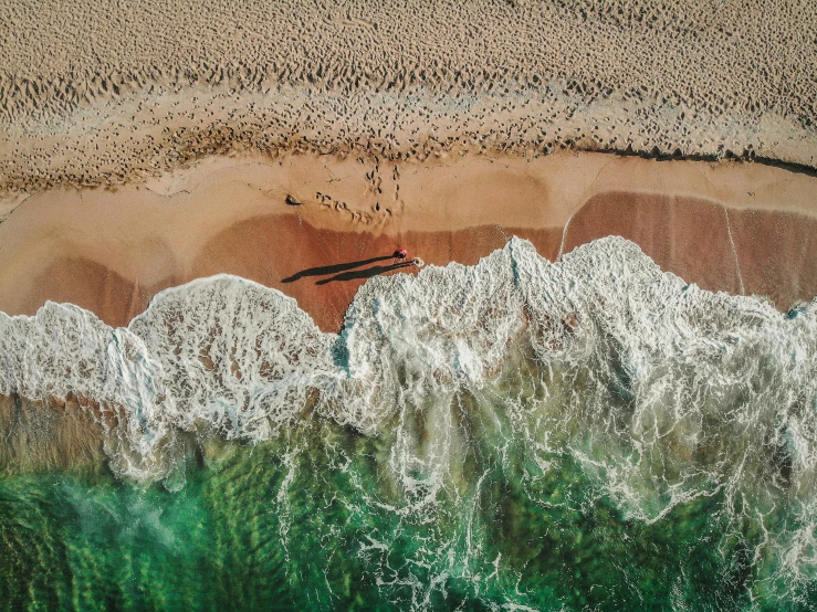 an aerial view of the sand, water and beach of a beach