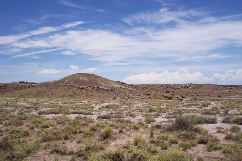 a large mountain with a small hill in the background