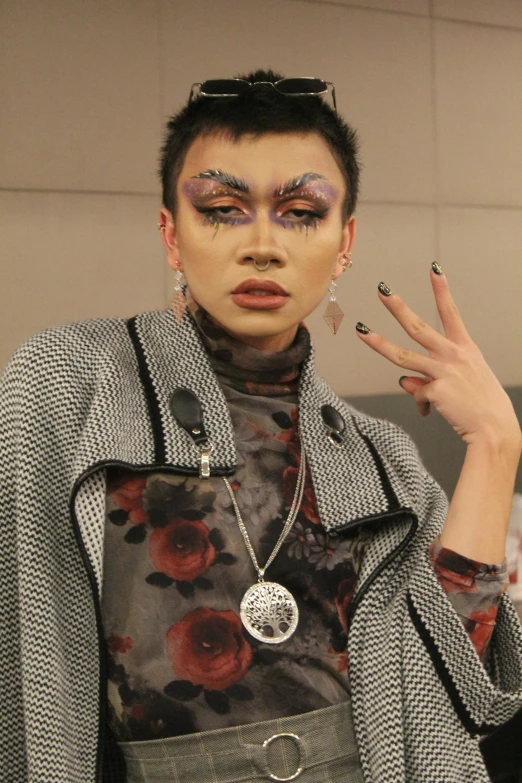 a woman in plaid jacket with makeup on display