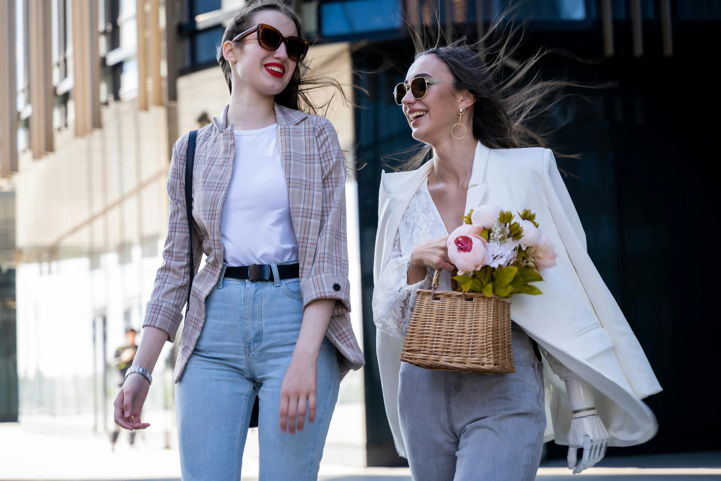 two women walking next to each other, talking