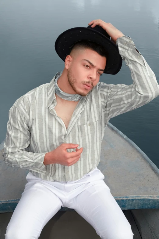 a man in a shirt and white pants
