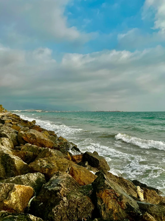 a boat sailing in the ocean on the shore