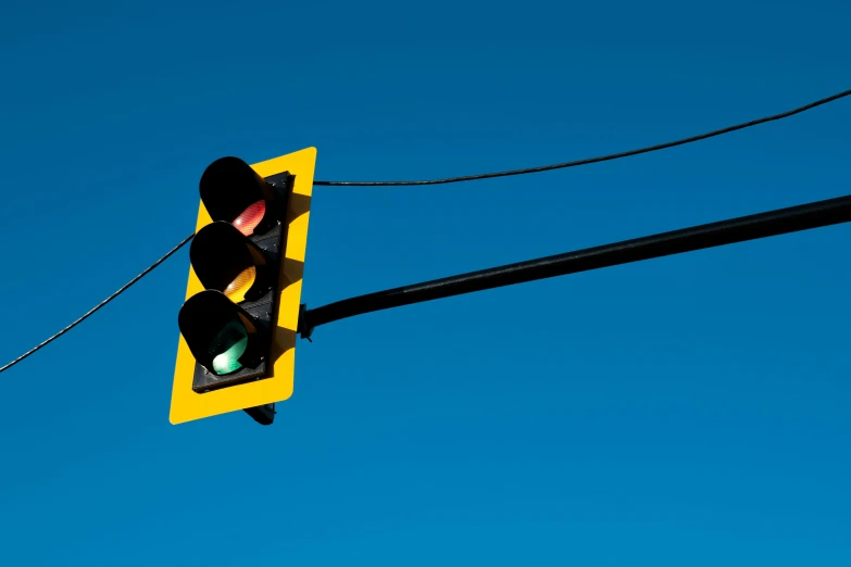 a traffic light hanging above a street with power lines