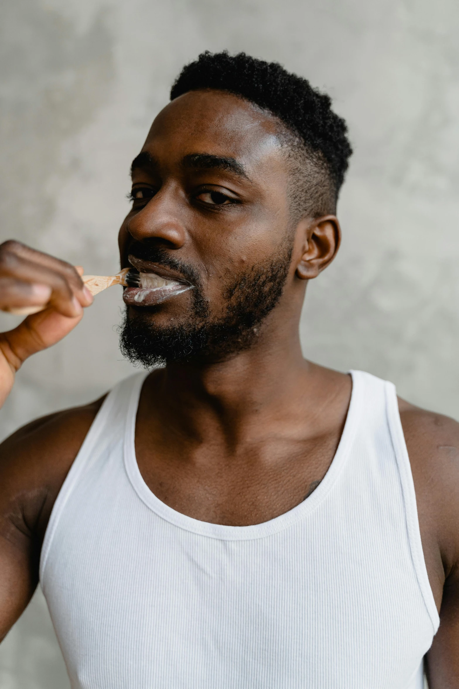 a man is holding a spoon and looking to the side