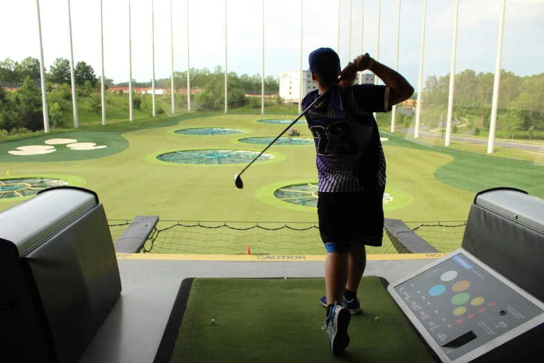 a person playing golf at a course in a building