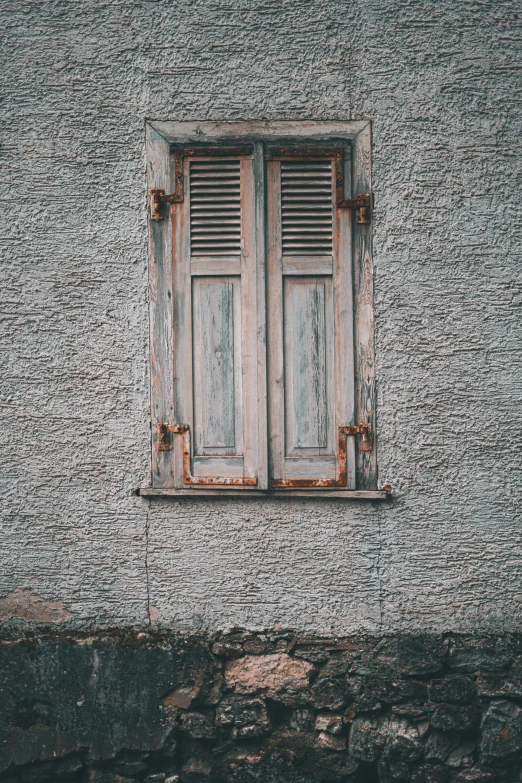 a wooden window with an old metal frame