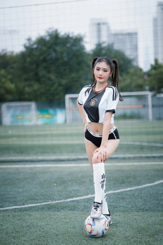 a young woman stands on the soccer field