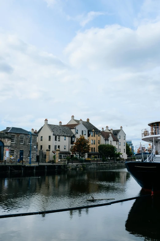 a boat is floating down the river next to houses