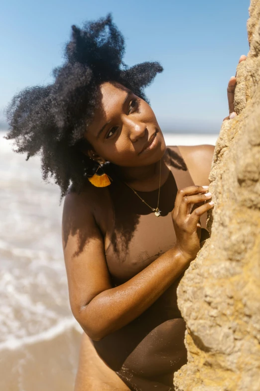 a woman standing by the beach posing for the camera