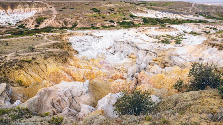 the land has layers of white and yellow rock