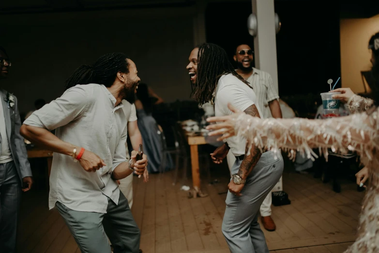 a group of people standing around in a room