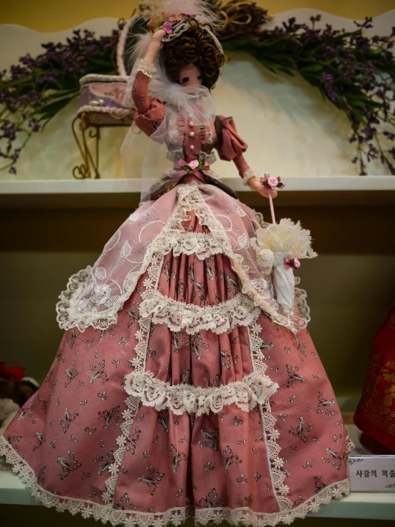 there is a doll that has a pink dress