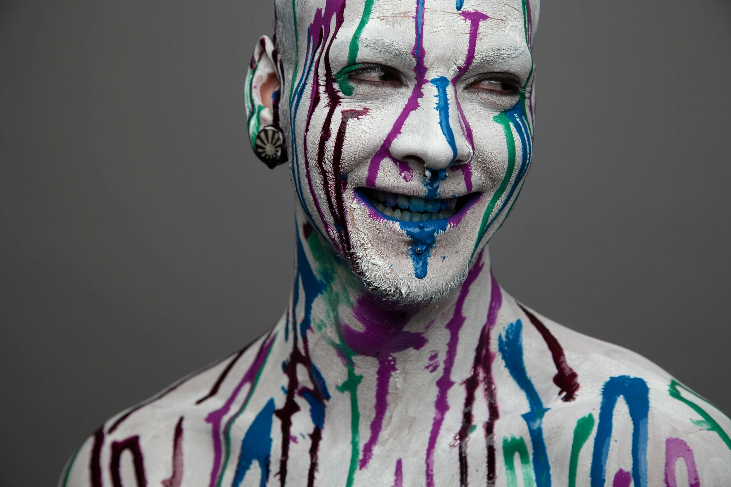 an altered pograph of a man with different colored paint on his body