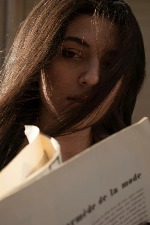 a close up of a woman holding a book