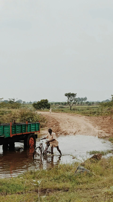 two people riding a bike down a stream