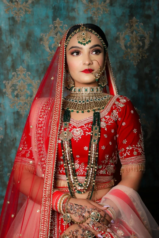 a beautiful indian woman wearing a bridal red dress