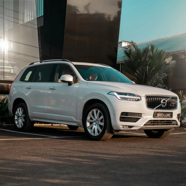 a white suv is parked in front of a building