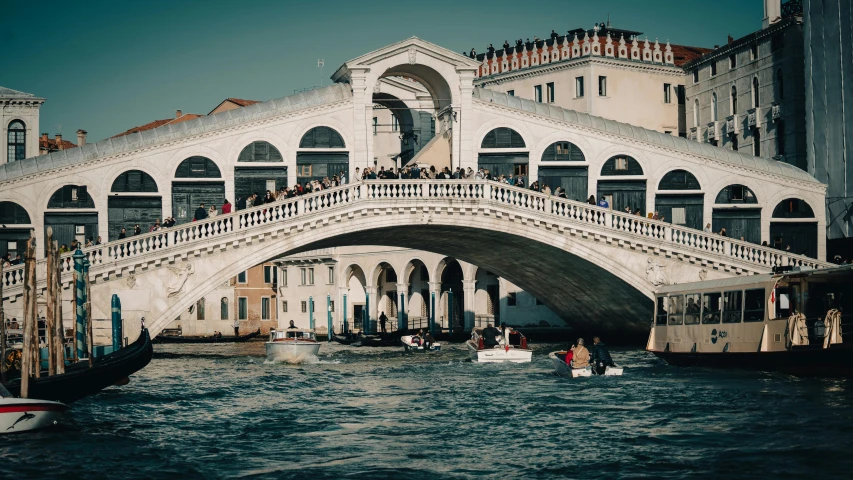 people are riding on the gondola as it comes down the canal