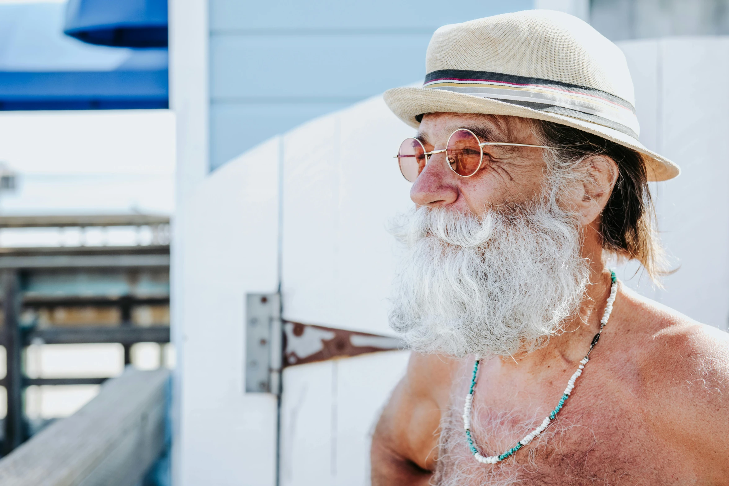 an old man wearing glasses and a hat