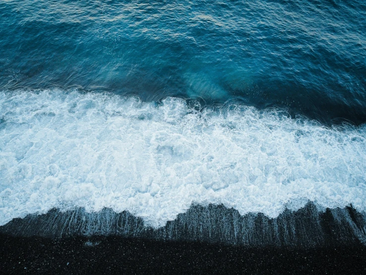 a large body of water with black and white waves