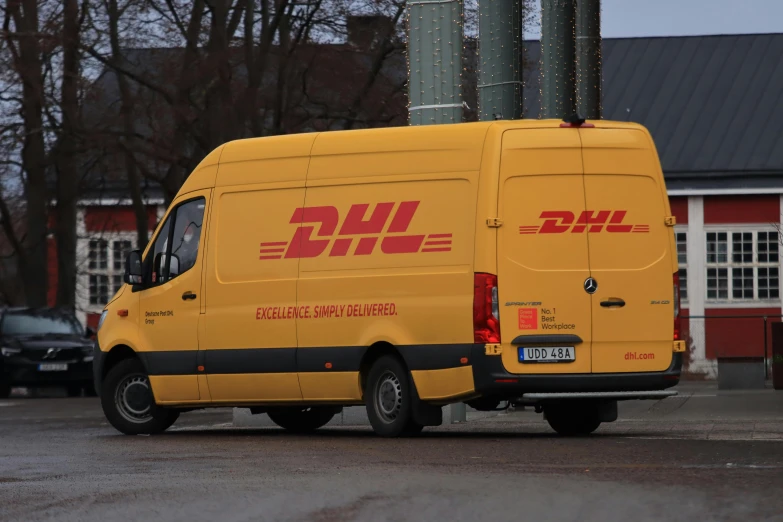 a yellow delivery van parked outside a building