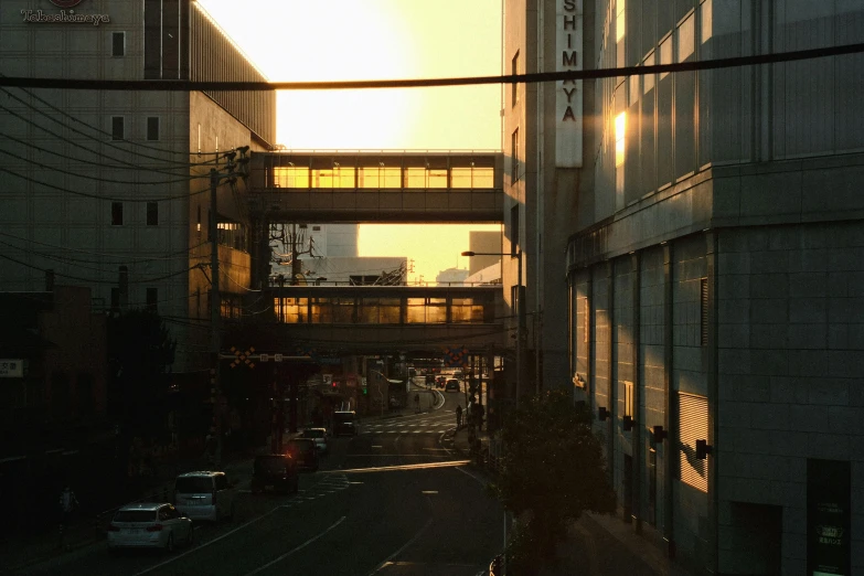 a city street with sun shining through a building