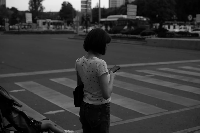 a girl with her back to the camera looking at her cell phone