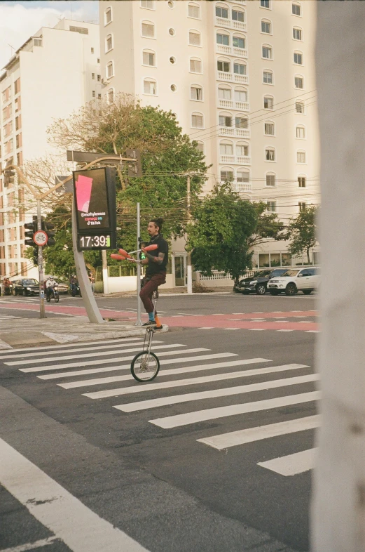 a young man on a bicycle in an intersection