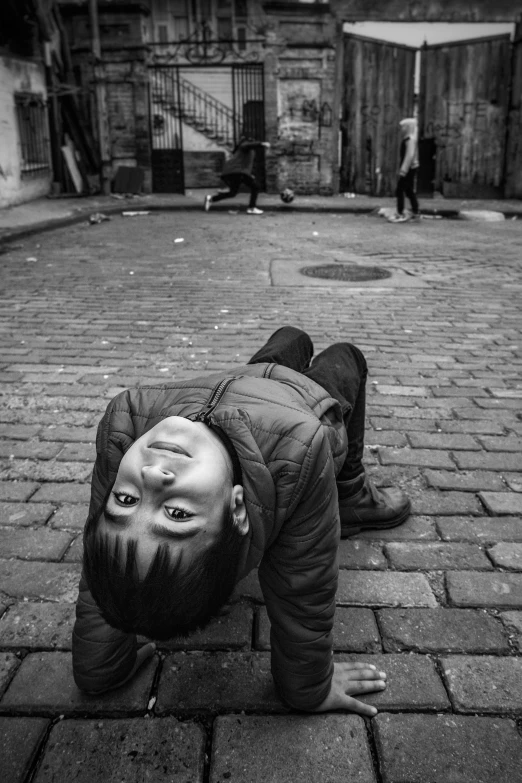 a person laying on the sidewalk in the street