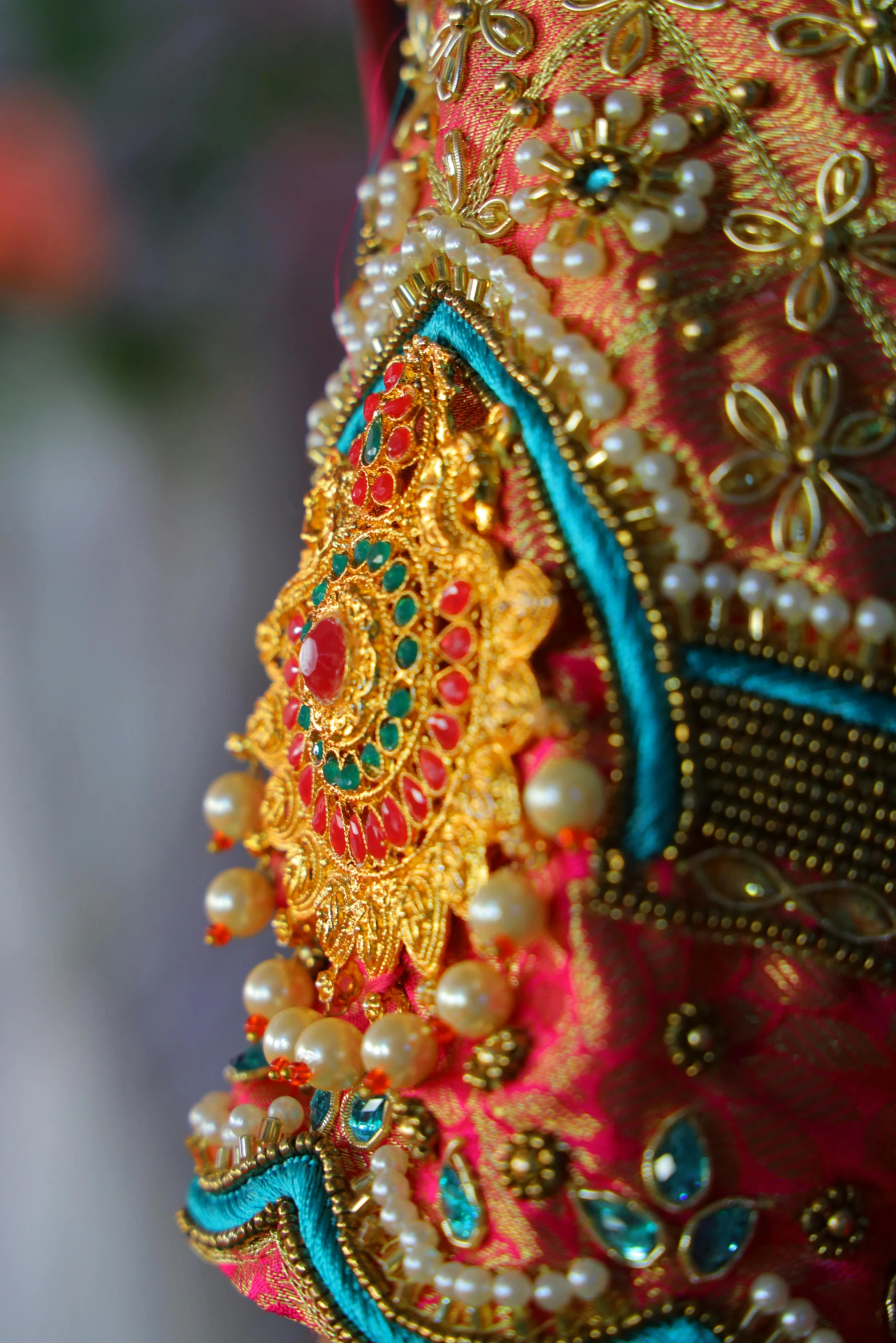 close up of a beaded red, yellow and blue cloth