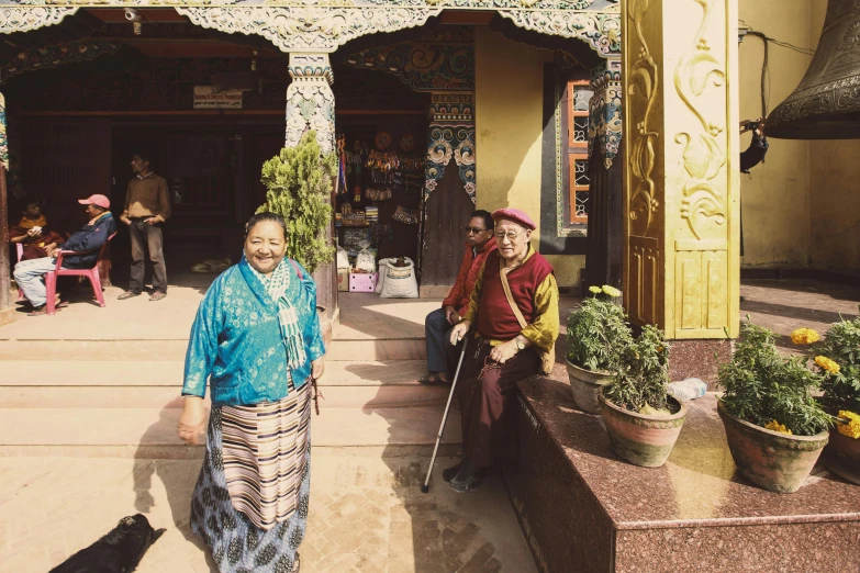 two people standing next to each other near pots